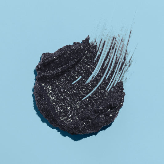 Charcal Smoothie black goop texture on a blue background