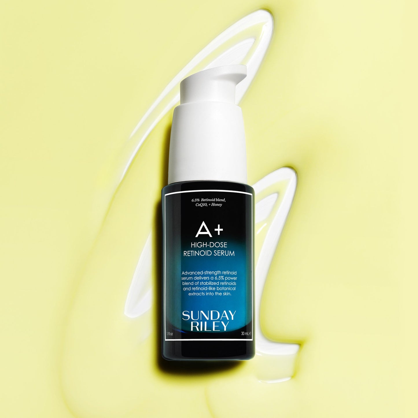 A+ High-Dose Retinoid Serum bottle lay down on a light green goop with texture