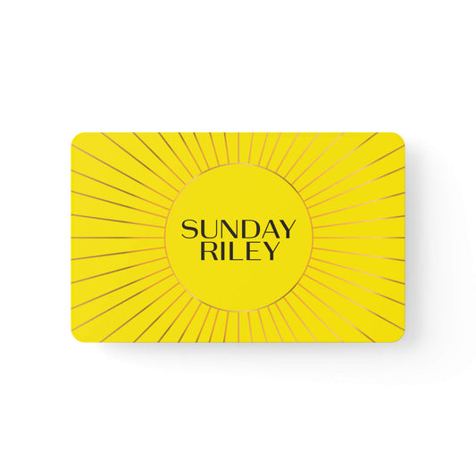 Sunday Riley Gift Card - Yellow card with a circle in the middle and gold lines from center to border similar to a Sun drawing with Sunday Riley logo in center