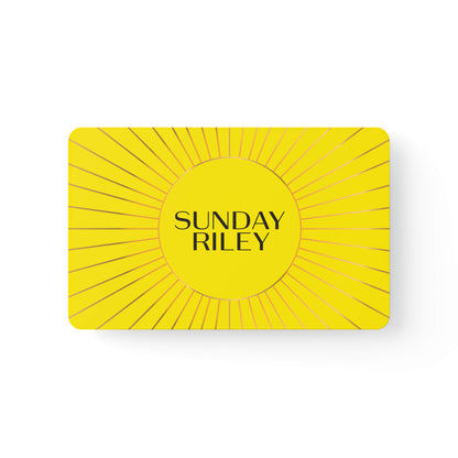 Sunday Riley Gift Card - Yellow card with a circle in the middle and gold lines from center to border similar to a Sun drawing with Sunday Riley logo in center